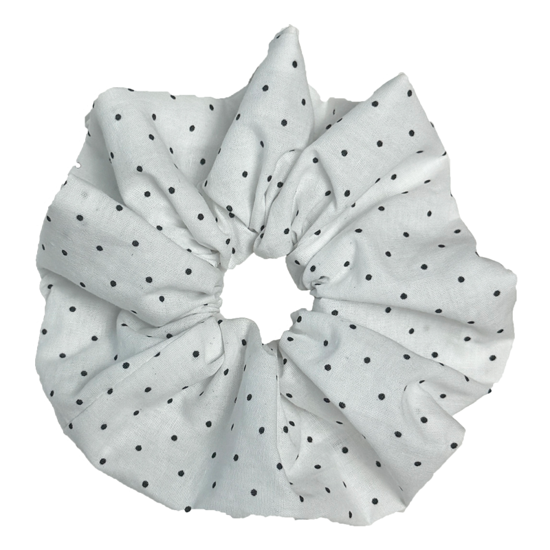Single white black polka dot scrunchie isolated on white background. Voluminous ruffled design with sharp dramatic folds.