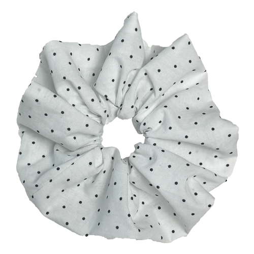Single white black polka dot scrunchie isolated on white background. Voluminous ruffled design with sharp dramatic folds.
