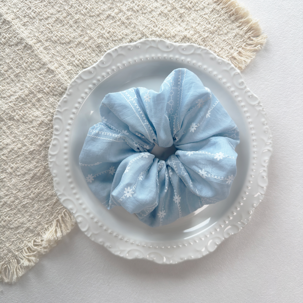 Artisanal blue floral scrunchie with premium embroidery, stylish wrist or hair accessory for cottagecore look.