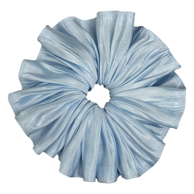 Single soft blue pleated satin scrunchie isolated on white background. Accordion pleats radiate from the center with luminous silvery highlights across the folds.