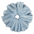 Single soft blue pleated satin scrunchie isolated on white background. Accordion pleats radiate from the center with luminous silvery highlights across the folds.