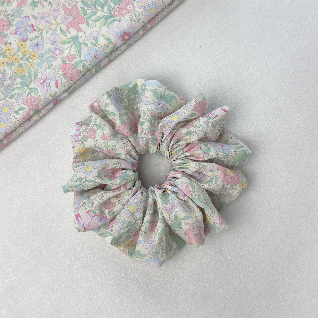 Vibrant floral scrunchie with matching fabric on white background, premium linen blend for mood-boosting style.