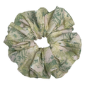 Single cream green floral print scrunchie isolated on white background. Voluminous ruffled design with watercolor sage and olive botanical print and subtle dusty pink accents.