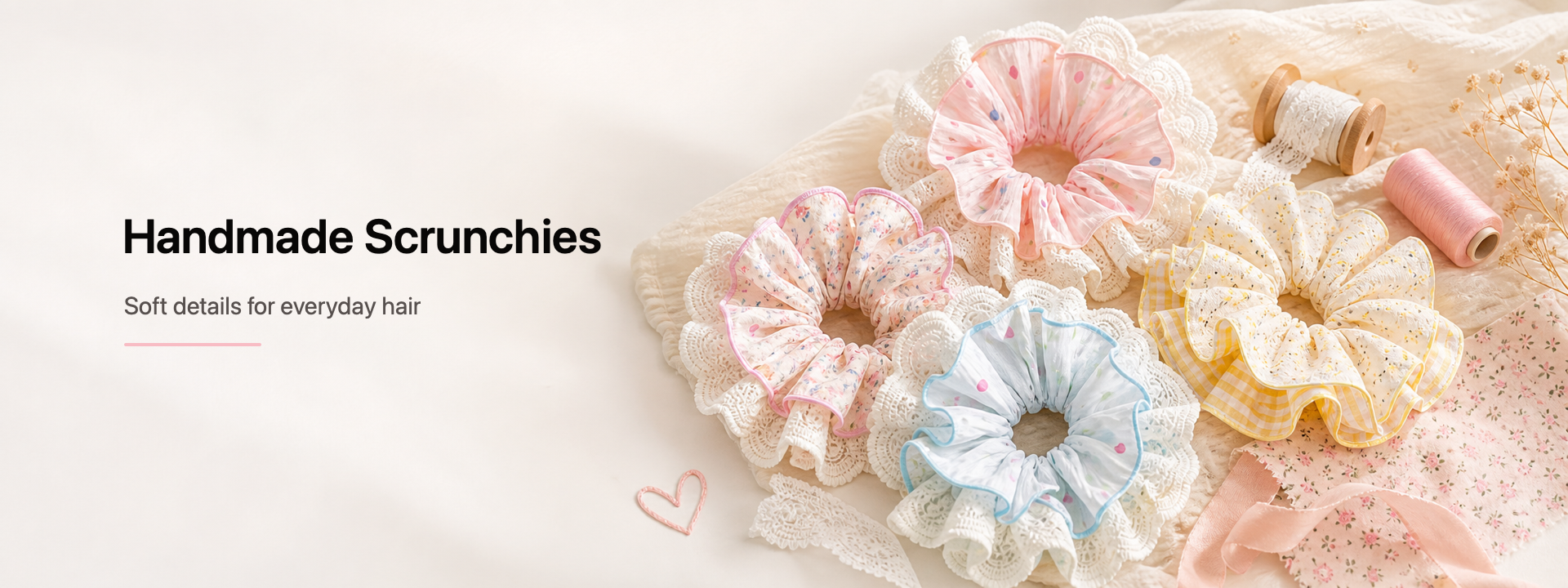 Brand image with "Handmade Scrunchies / Soft details for everyday hair" text on the left, alongside a flat-lay of four lace-trim scrunchies in pink, blue, and yellow gingham patterns with sewing props, dried flowers, and a pink wire heart on a cream crinkled fabric background.