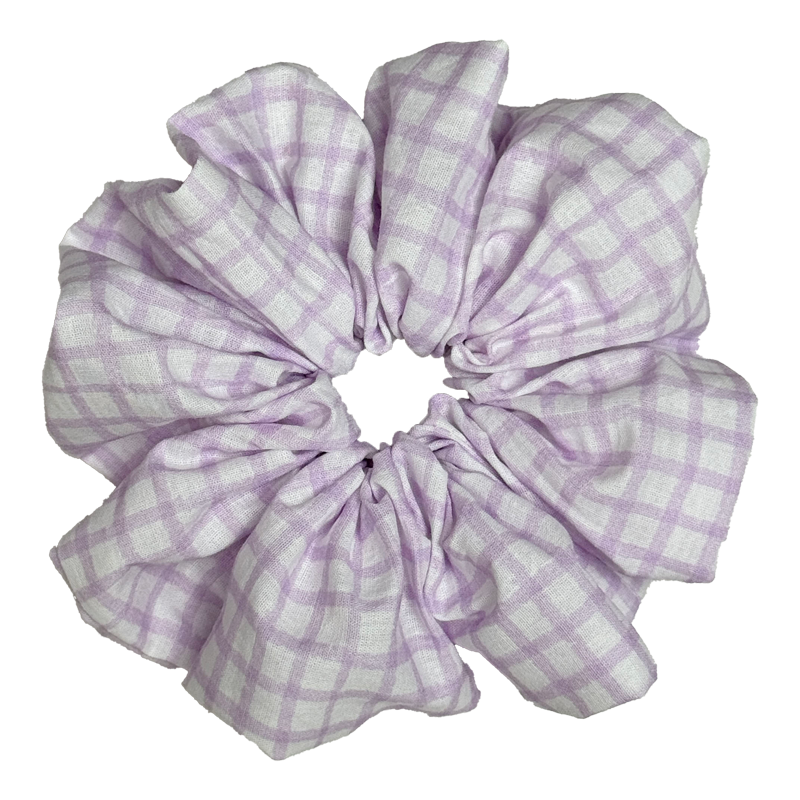 Single lavender windowpane plaid scrunchie isolated on white background. Voluminous ruffled design with thin purple grid lines on a crisp white cotton base.