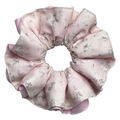 Single dusty blush floral print scrunchie with a solid medium pink underlayer peeking through the ruffles, isolated on white background. Voluminous double-layer design with faded grey-lavender floral print.