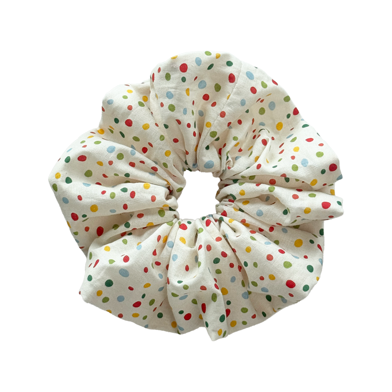 Polka dot linen scrunchie in cream, gentle hair tie with no crease protection.