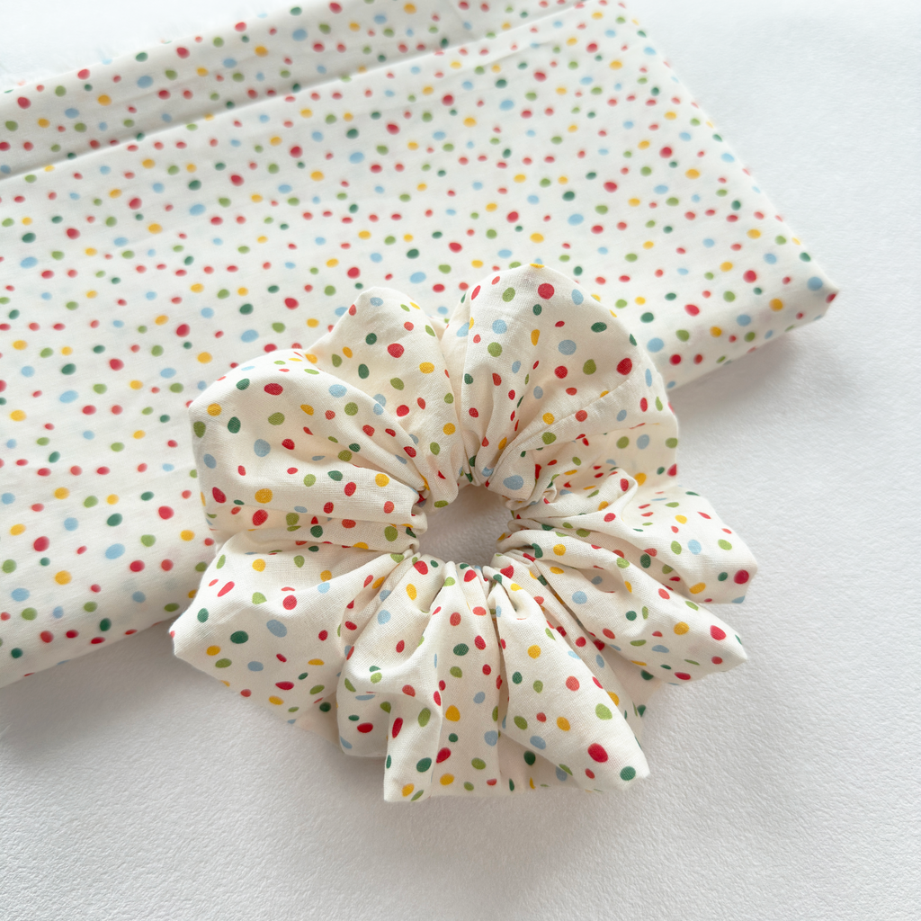 Durable elastic stretch of a polka dot linen scrunchie for all hair types.