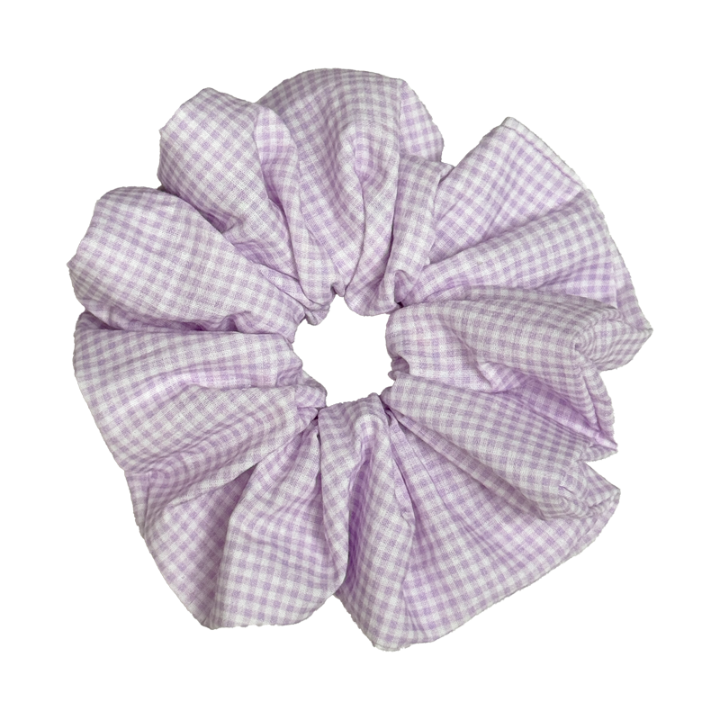 Single lavender and white gingham scrunchie isolated on white background. Voluminous ruffled design with crisp woven cotton texture and deep soft folds.