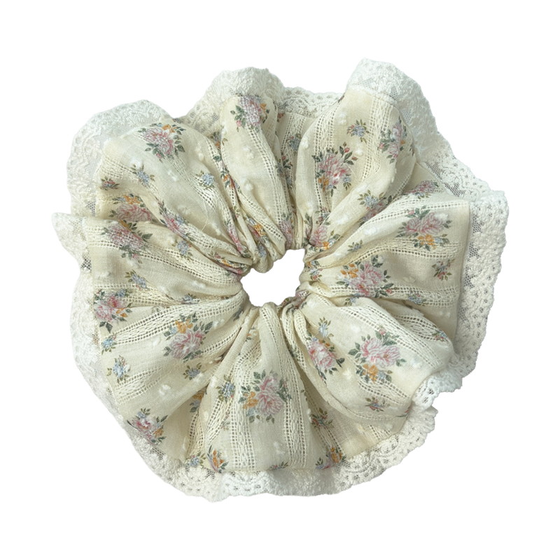 Front view of a yellow floral lace scrunchie on cream linen, sweet vintage floral print and lace trim.